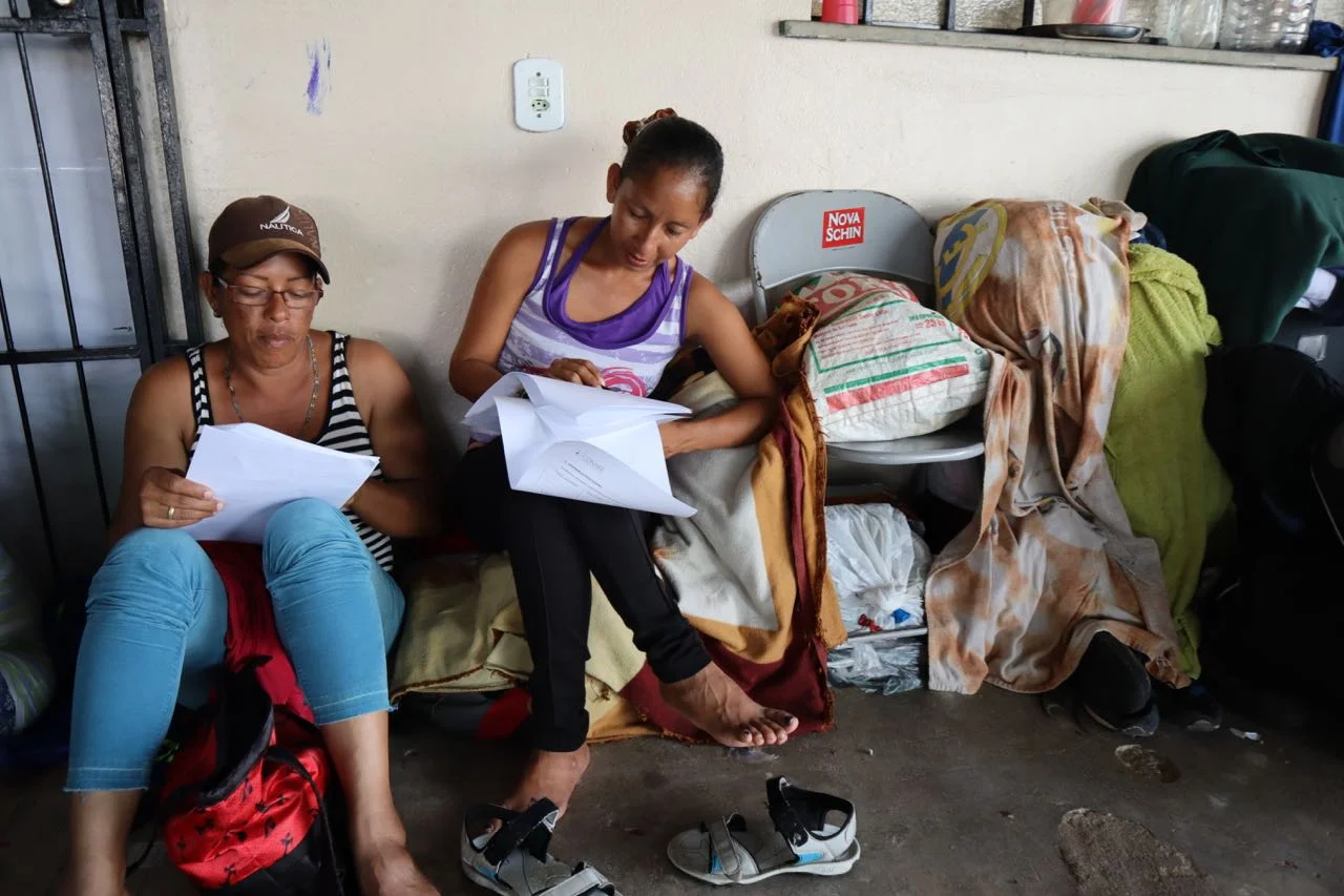 Women filling in their asylum registration paperwork, at shelter in Boa Vistsa. 