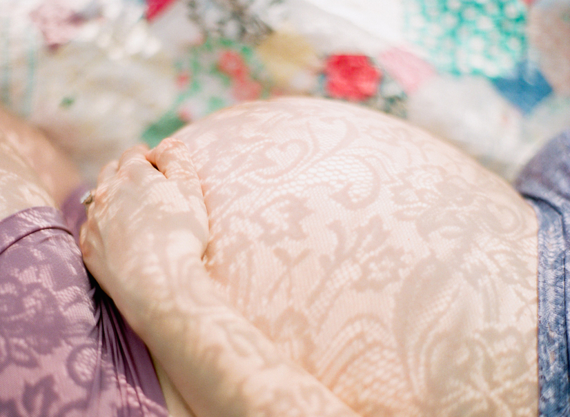 pregnant woman with hands on belly and lace fabric .jpg