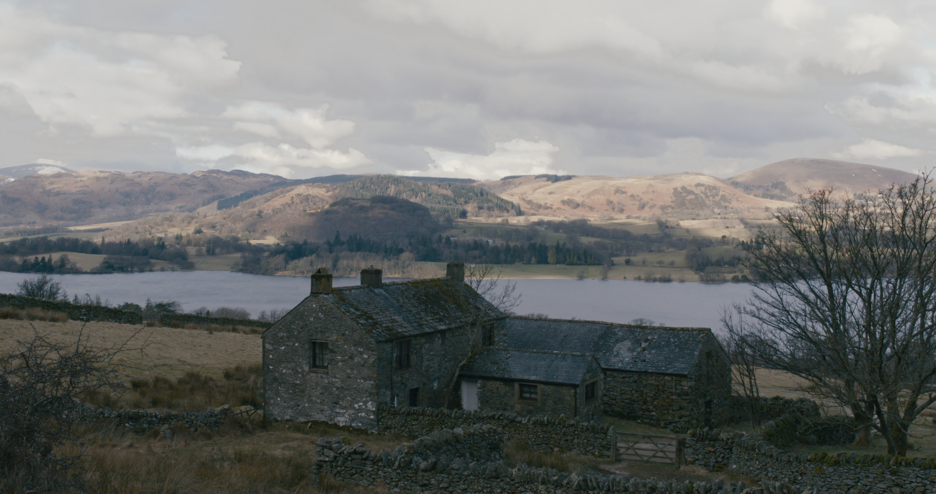 EXT. COTTAGE - The old house at the foot of the fell overlooks the lake