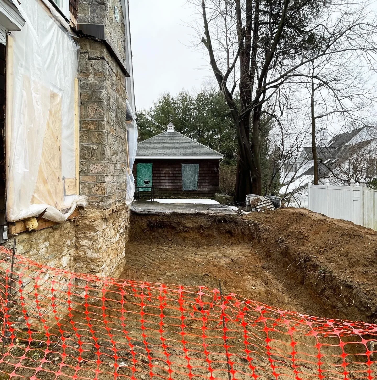 Excavation work for foundations of two small residential additions on a house in the Bronxville area of Westchester County. The one on the west side went as planned and the one on the south encountered a rock ledge about a foot below the soil. Redesi