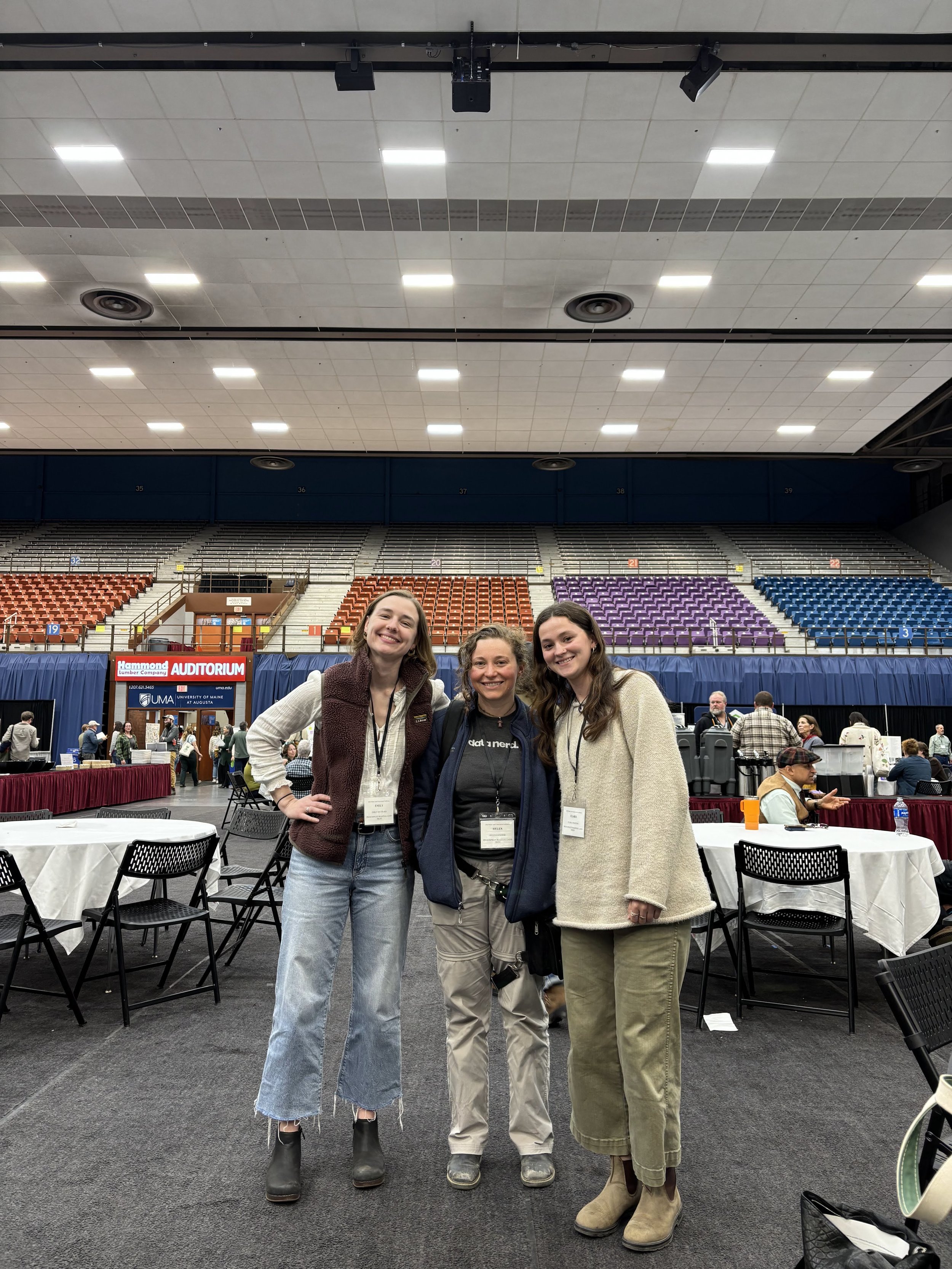 three staff members posing in the civic center's main room