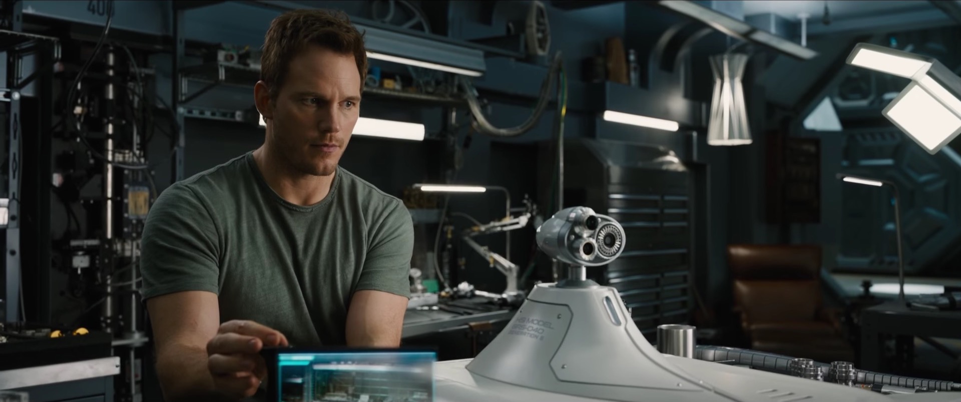 Chris Pratt modifying a robot aboard Avalon in Passengers