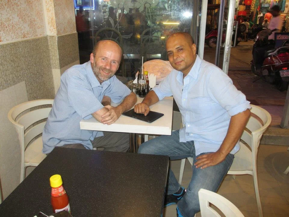 Matt and a friend enjoying a cup of chai in New Dehli.