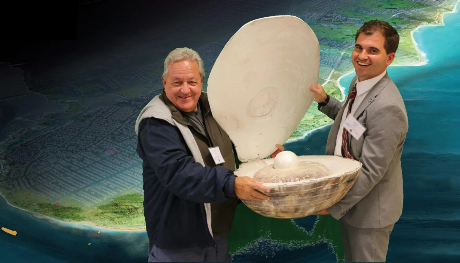 Malizia and Alex Zablocki, former senior project manager with the Governor's office of storm recovery, pose with a giant oyster, a map of the Living Breakwaters site in the background.