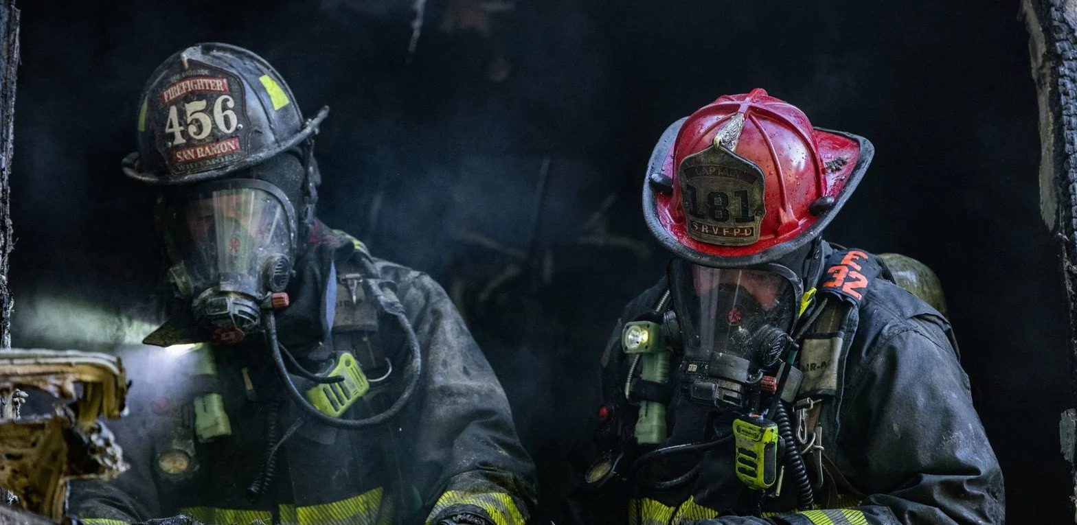 Two San Ramon Valley firefighters conducting overhaul at a structure fire