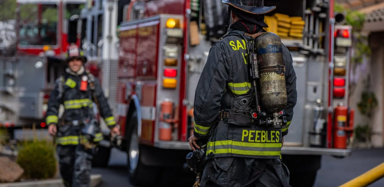 Firefighter walking toward San Ramon Valley fire engines at an incident