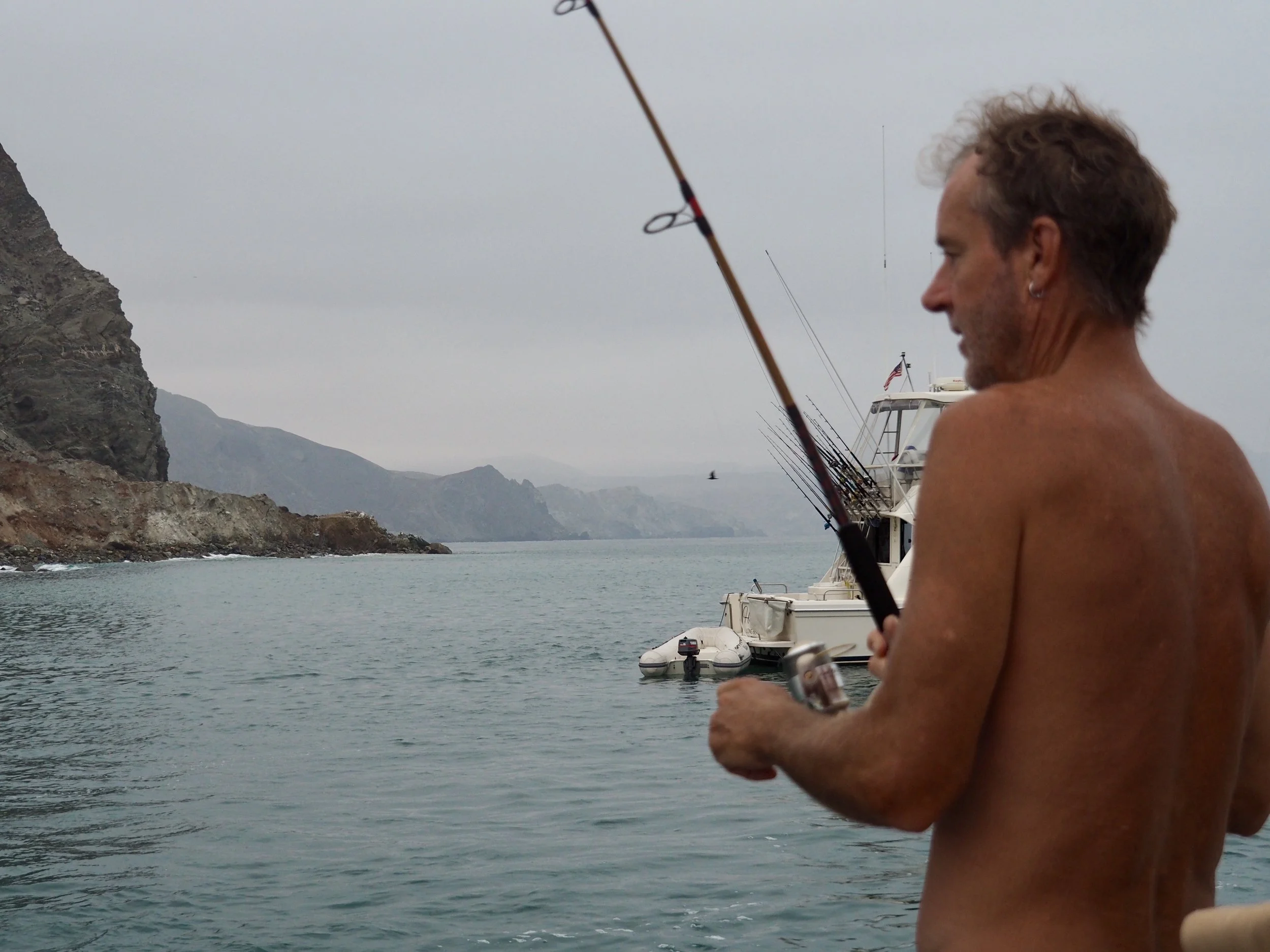 Woken by the call of the wild knocking on our hull, Colin wasted no time going after whatever was chasing the boiling mackerel around the boat
