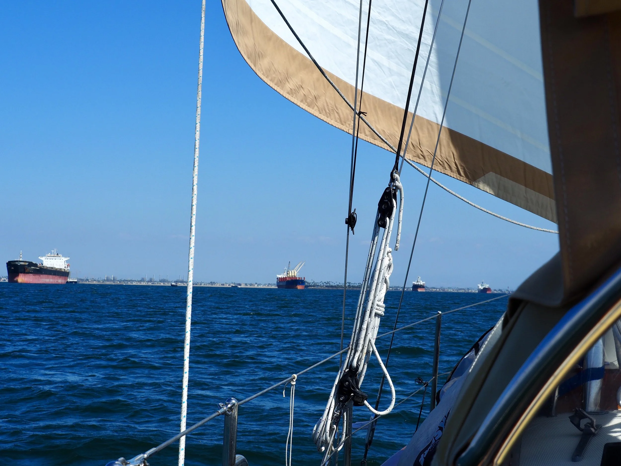 Dodging anchored freighters under sail on the way out of Long Beach Harbor.