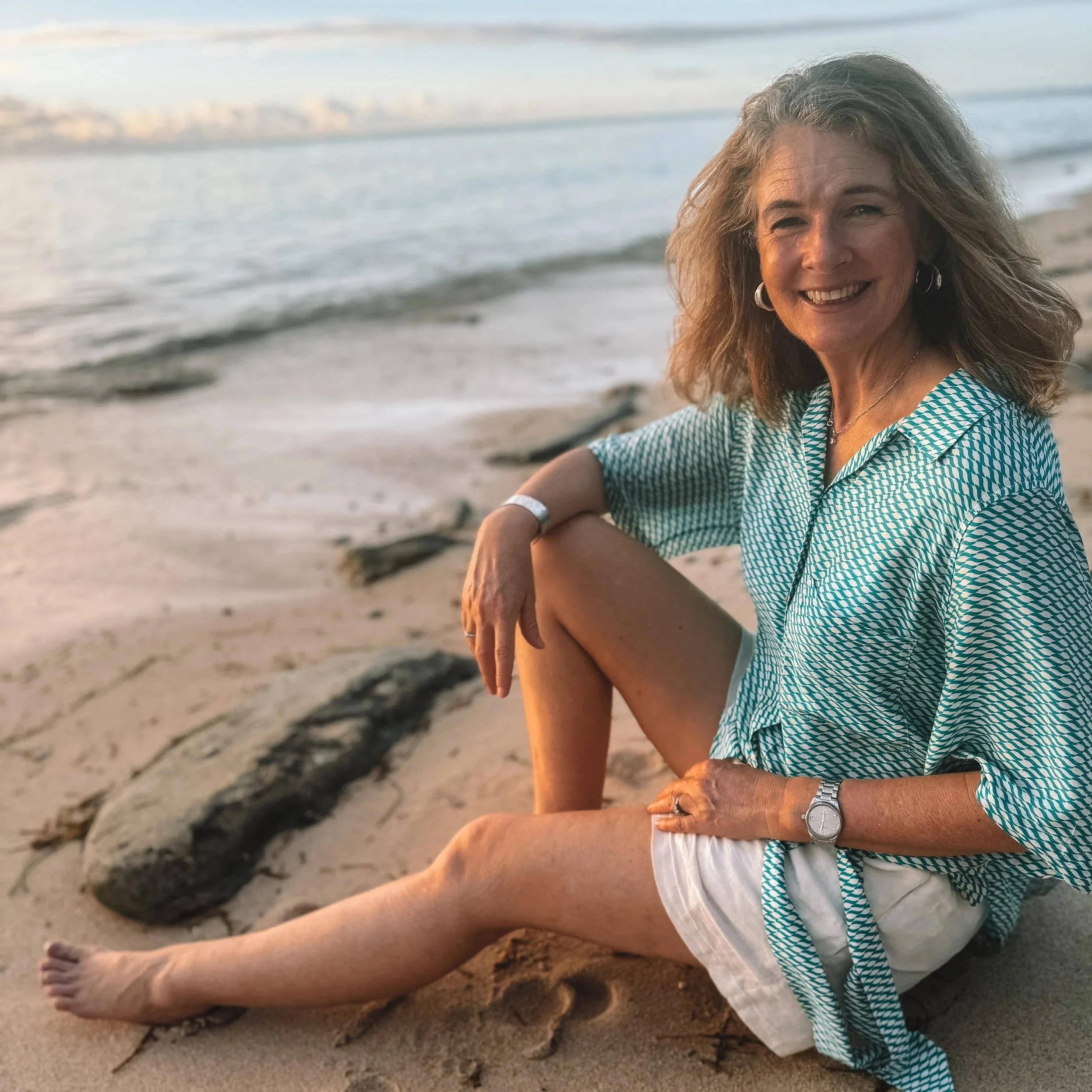Alex co-director of Tokoriki Diving, sitting on beach.