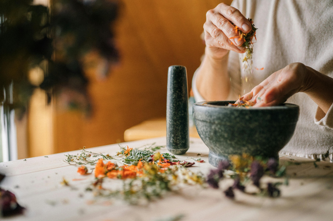 Hands formulating custom botanical remedies for 3-visit naturopathic package in NYC