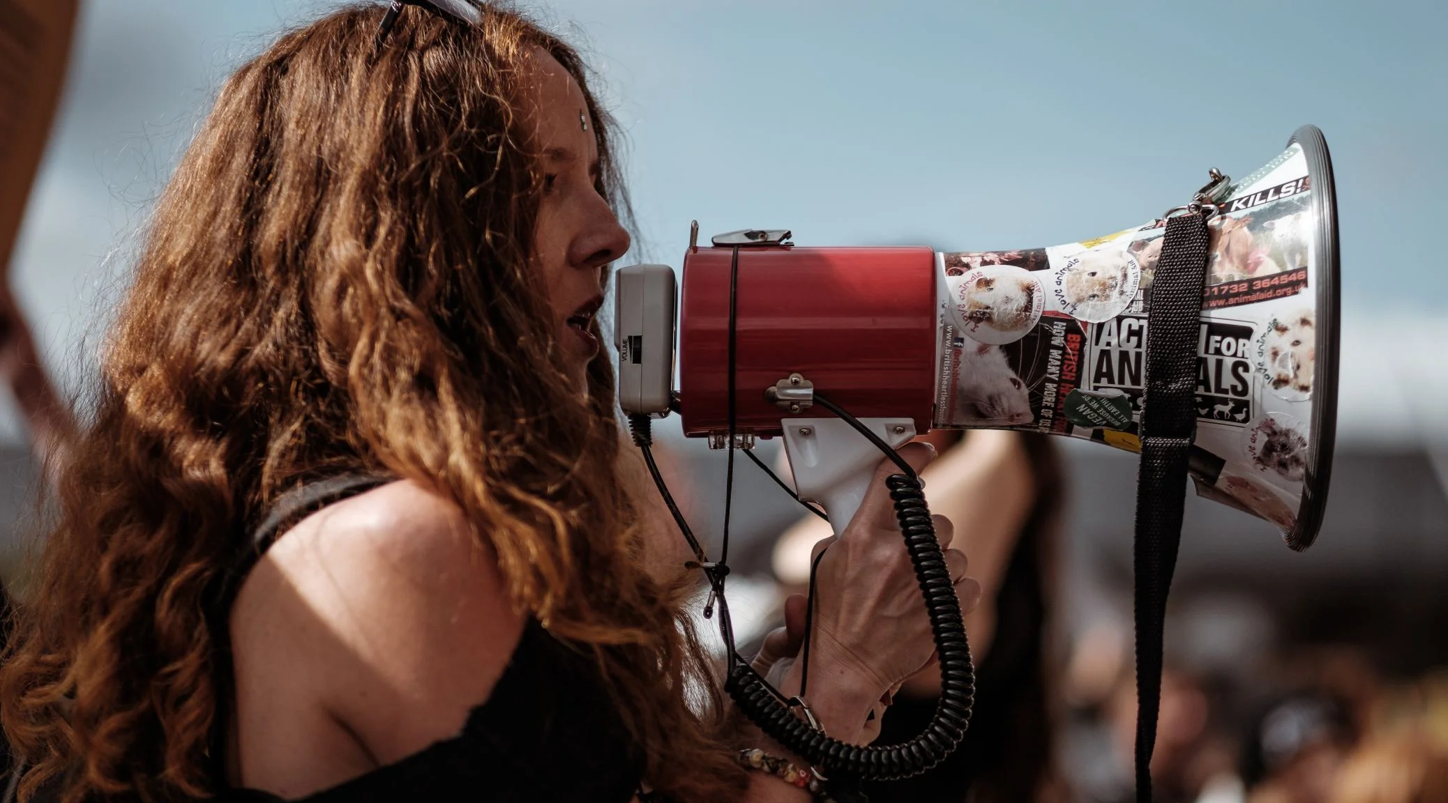 Woman holding bullhorn at demonstration.