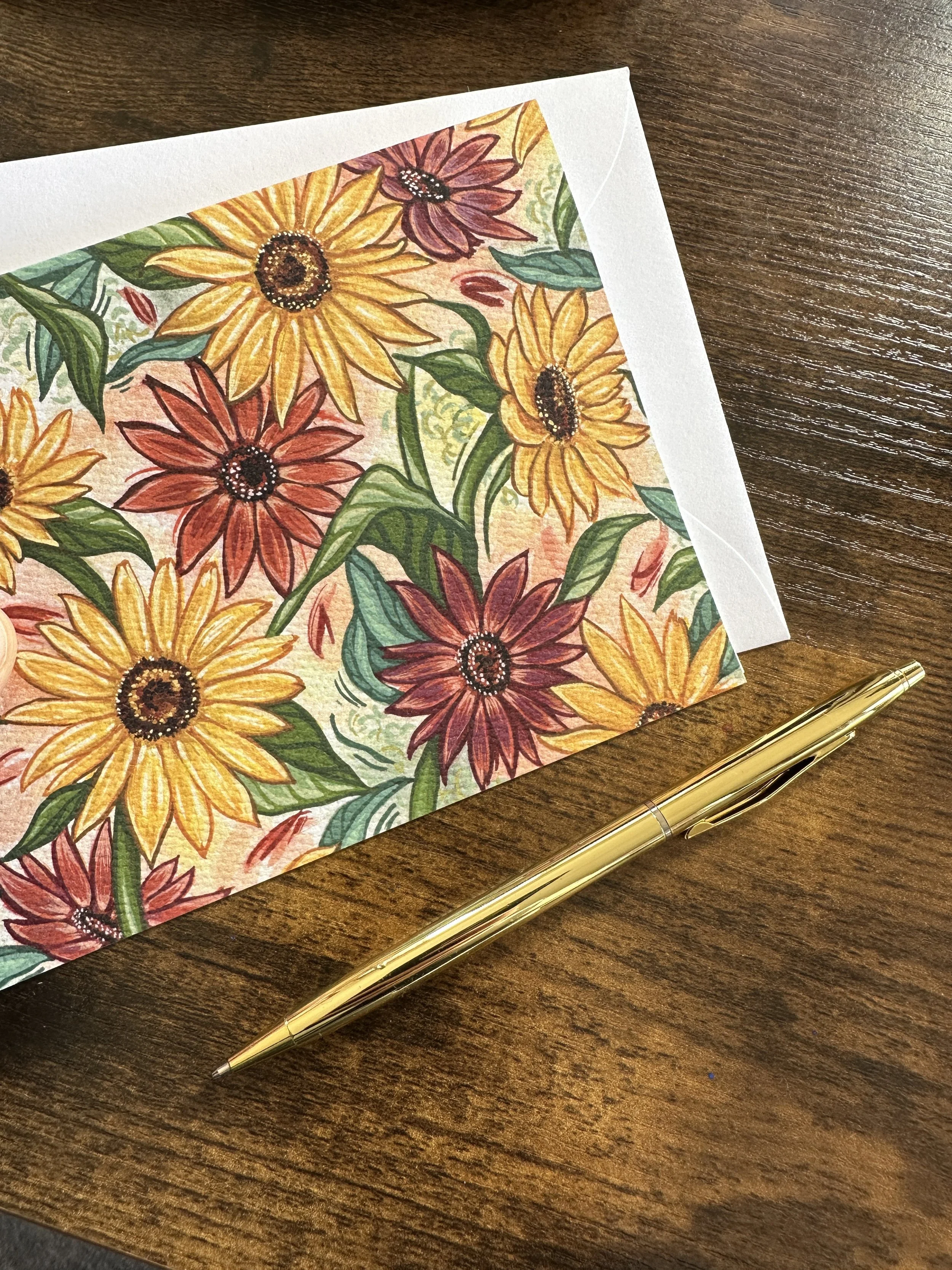 Sunflower painting is featured on the front of a folded notecard.
