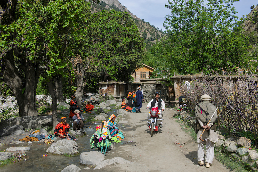 Kalash girls washing clothes in a stream at Balangur Village, Rumbur Valley, Chitral.jpg