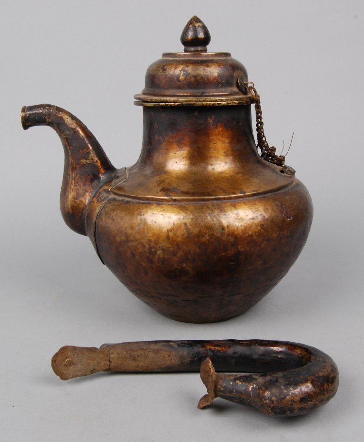 Lid made of metal with onion-shaped knob on top and chain at one side-ladakh