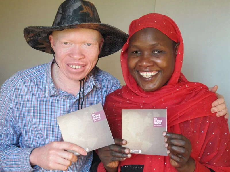 Peter & Fazira, a vital part of Advantage Africa’s team on the ground in Uganda, hold their copies of Martyn Joseph’s “Kiss the World Beautiful”.