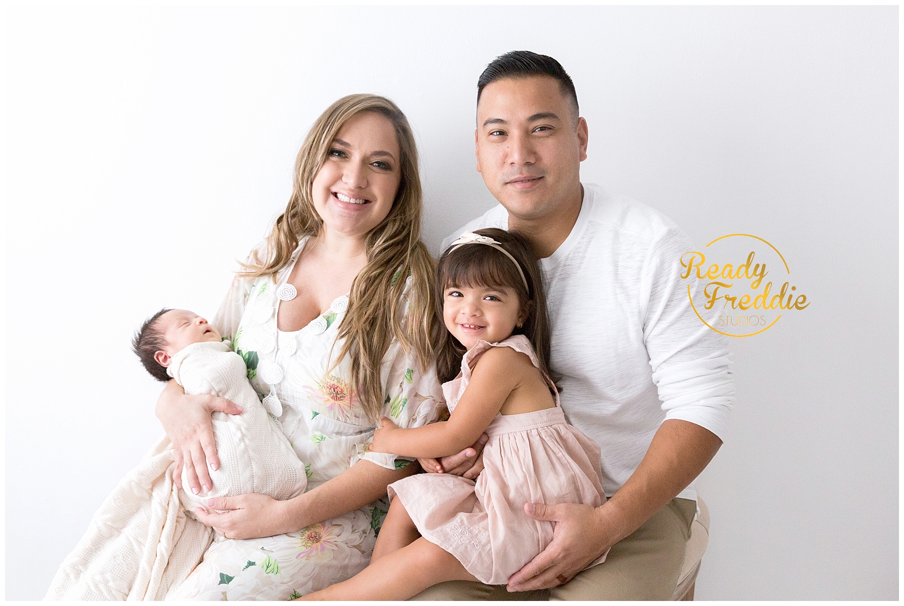 family picture mom dad toddler and newborn
