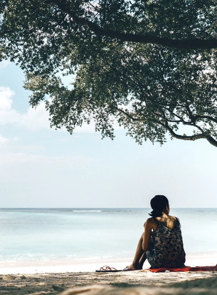 Woman sitting alone on beach Photo Credit Joshua Newton.jpeg