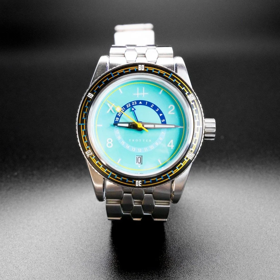 &mdash;Trotter GMT: Aqua dial w/Steel coffin-link bracelet

The Trotter keeps the proportions just right &mdash; a true 39mm case, 20ATM of water resistance, and the kind of balance that disappears on the wrist.

A fourth hand tracks a second timezon