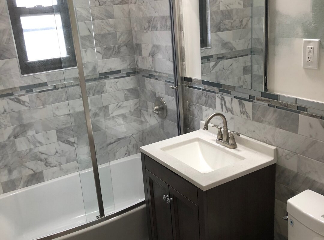 Bathroom gray tile with mosaic accent and brushed nickel hardware_queens apartment.jpg