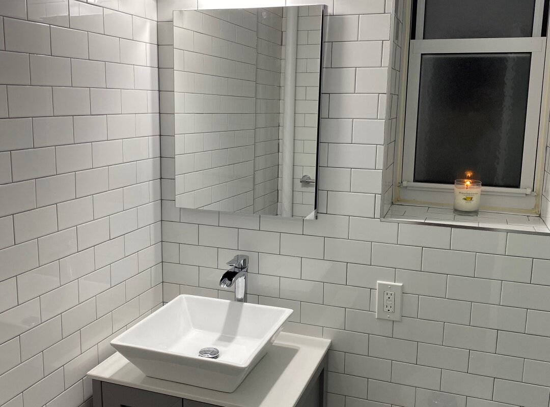 Bathroom white subway tiles brick patter with gray grout vessel sink_queens apartment.jpg