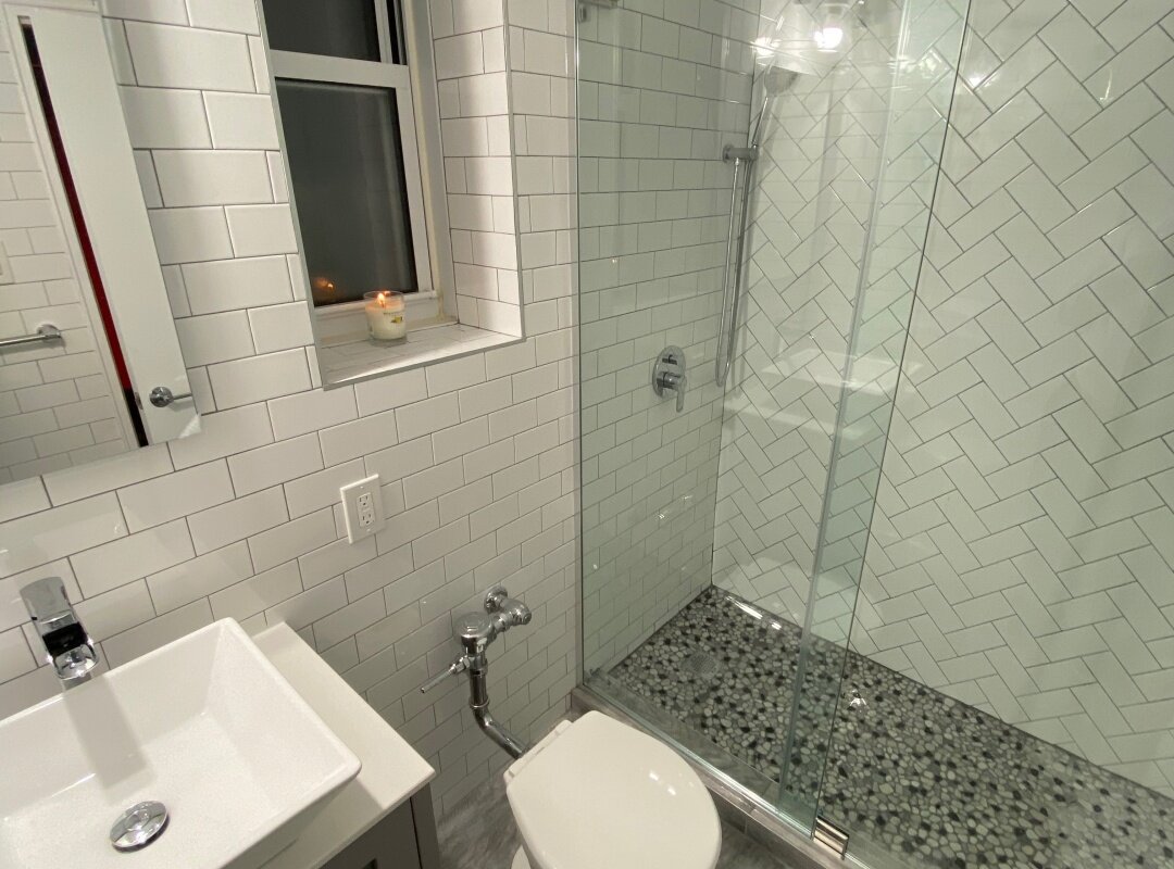 Bathroom white subway tiles different patterns_queens apartment.jpg