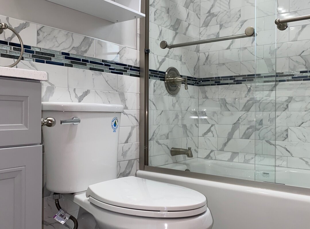 Bathrooom gray and white tiles with mosaic accent strip _queens house.jpg