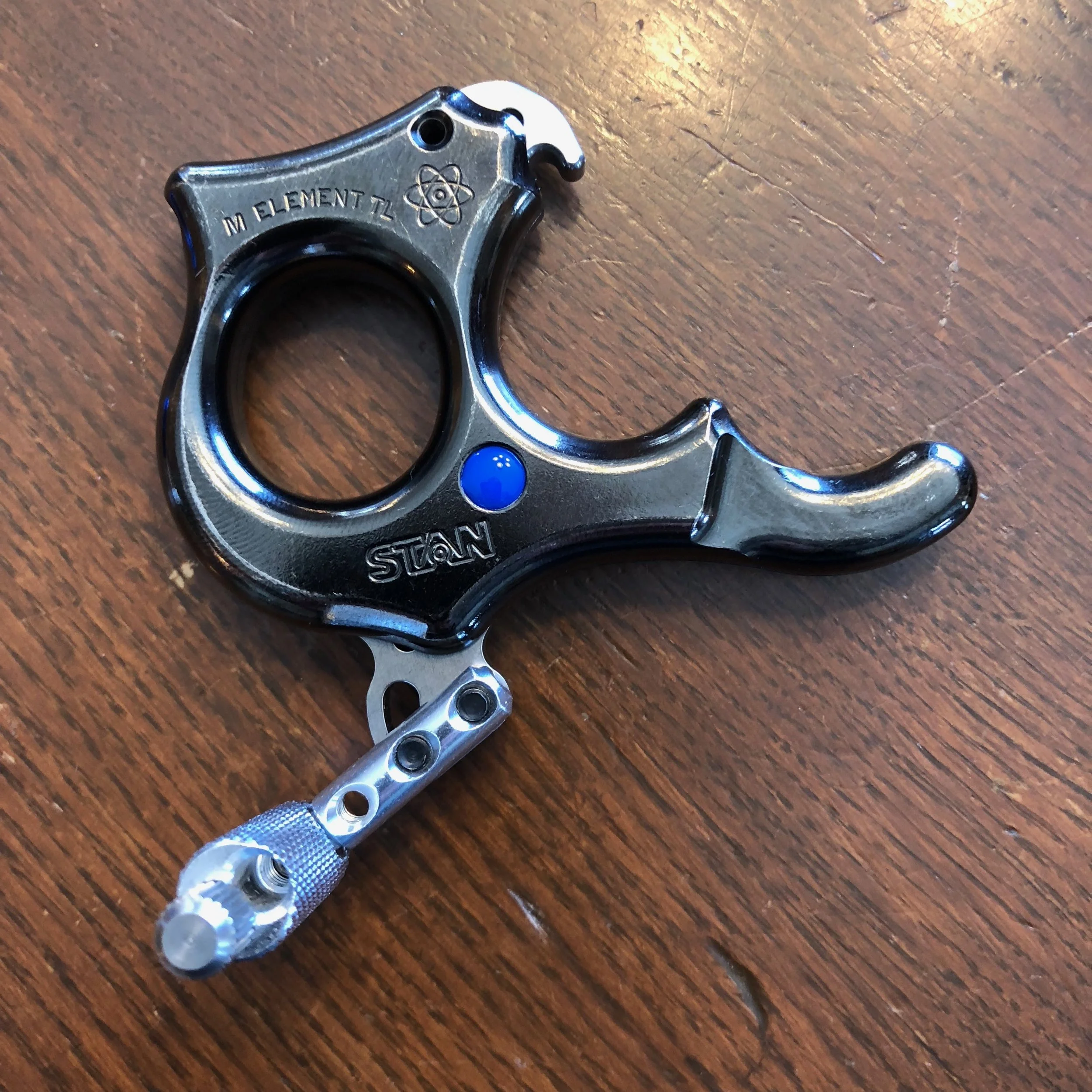Stan Element Heavy Metal ($190) This is one of Stan's famous tension release aids. The heavy metal version is extra heavy (nickel-plated copper) which helps steady your shot. This one is a medium, and they run a bit small. Might be too small for some adult-sized hands. Currently $259 at Lancaster Contact Coach Tim at 612-599-5470.