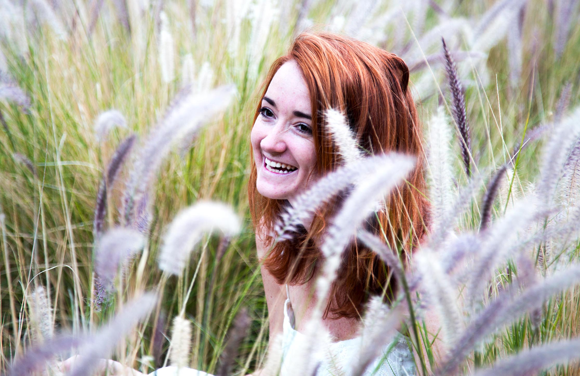 girl-laughing-in-a-field-of-grass.jpg