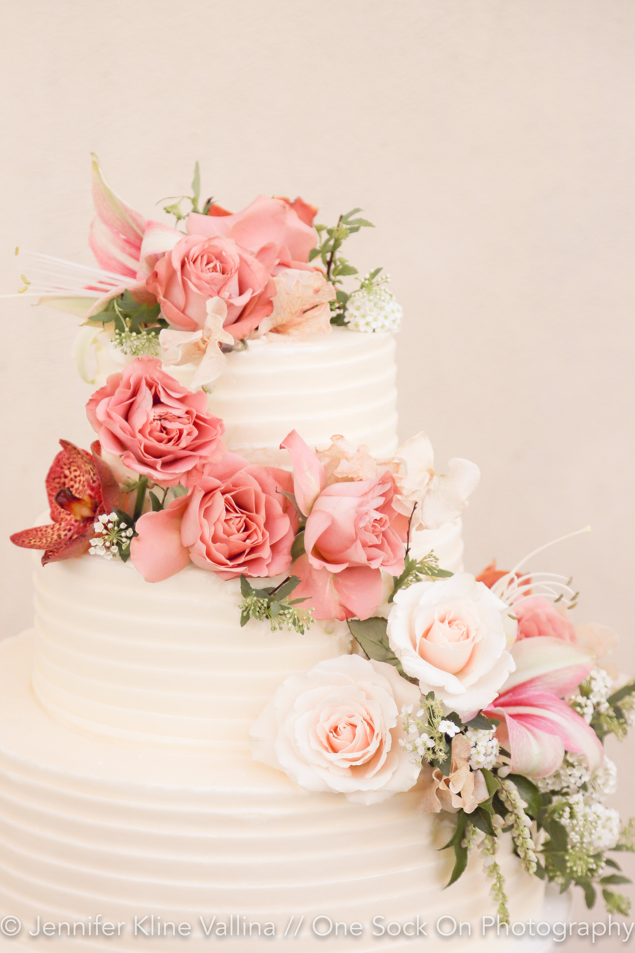wedding cake with fresh flowers cascading buttercream 