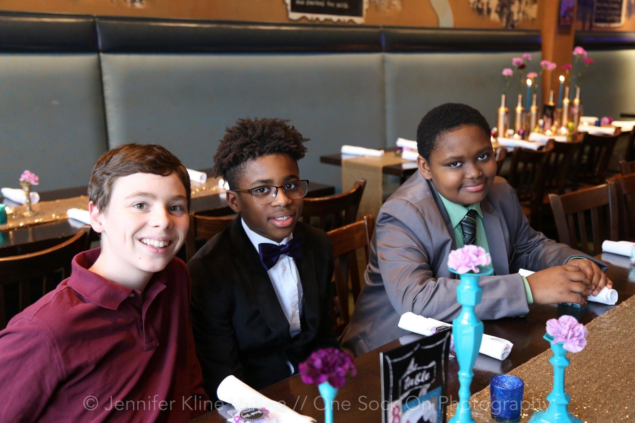 three teen boys smiling 