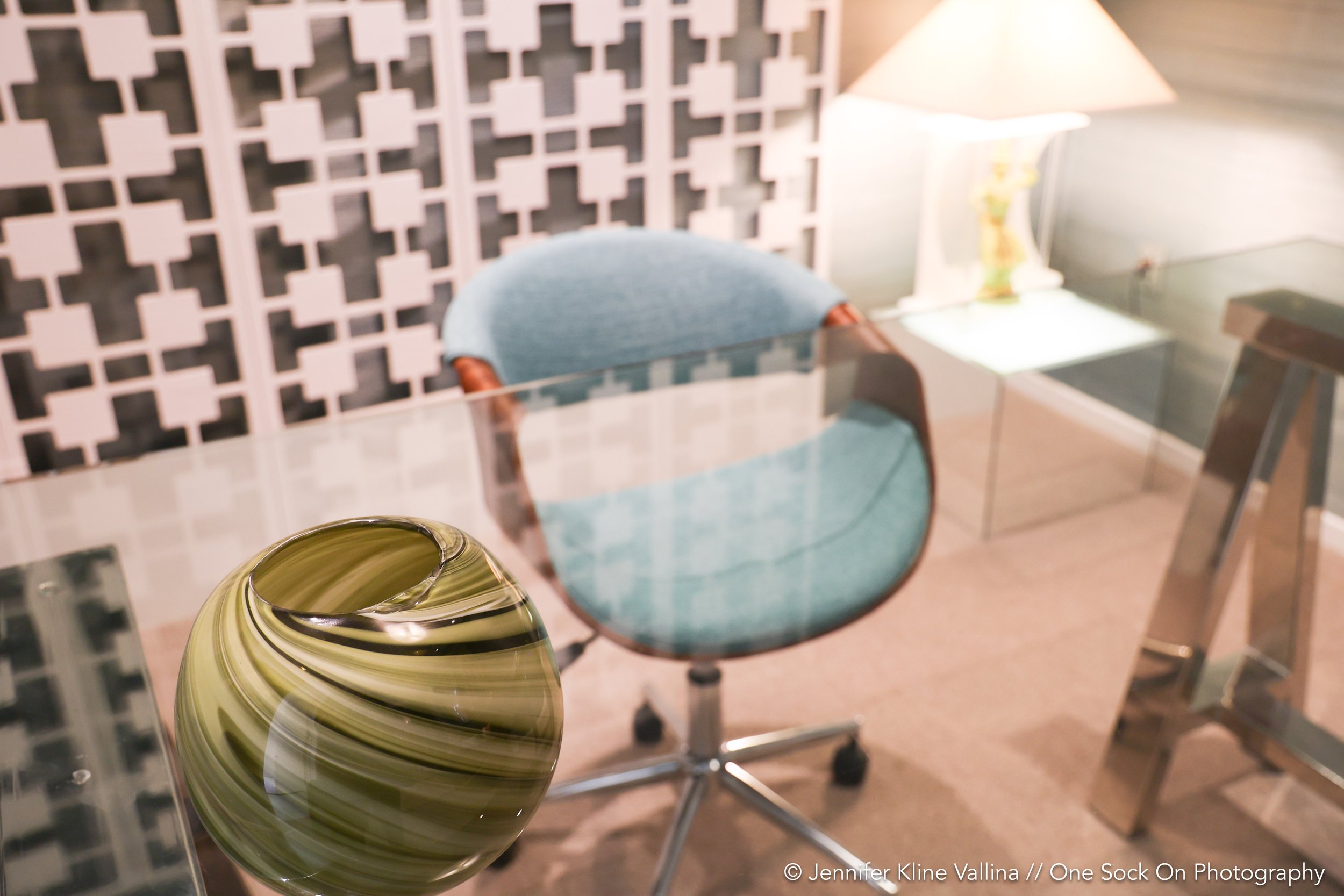 glass desk light teal fabric desk chair seen from above
