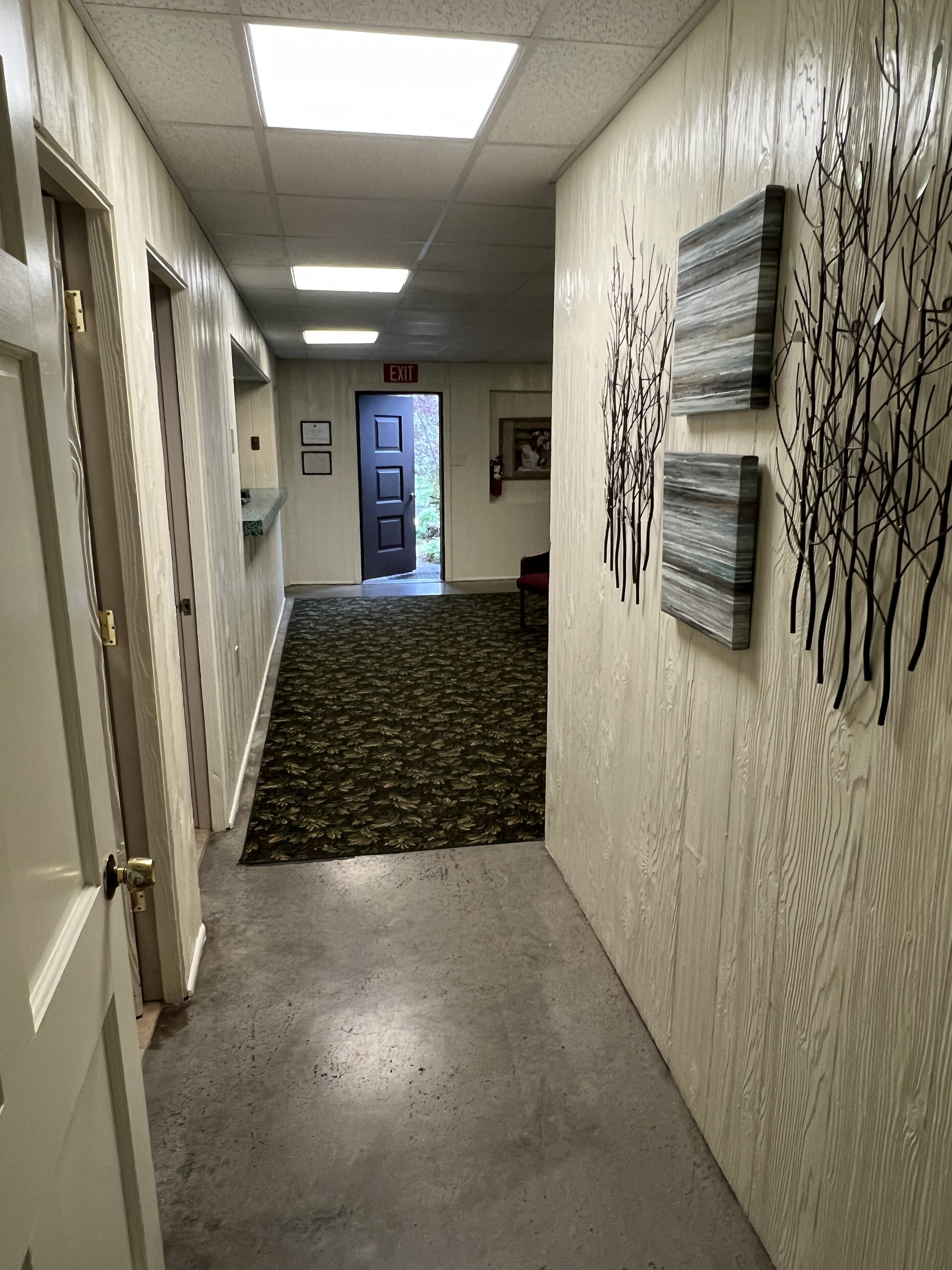 Hallway from back towards front foyer entry. Restrooms are on the left.