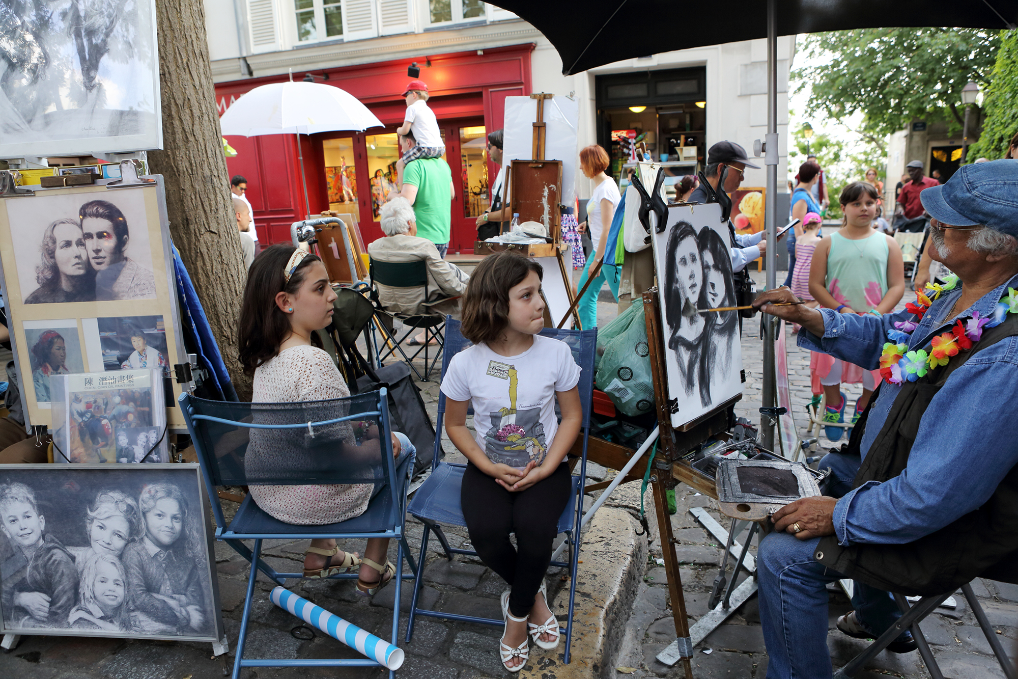 Sitting for a portrait in Montmartre, Paris.