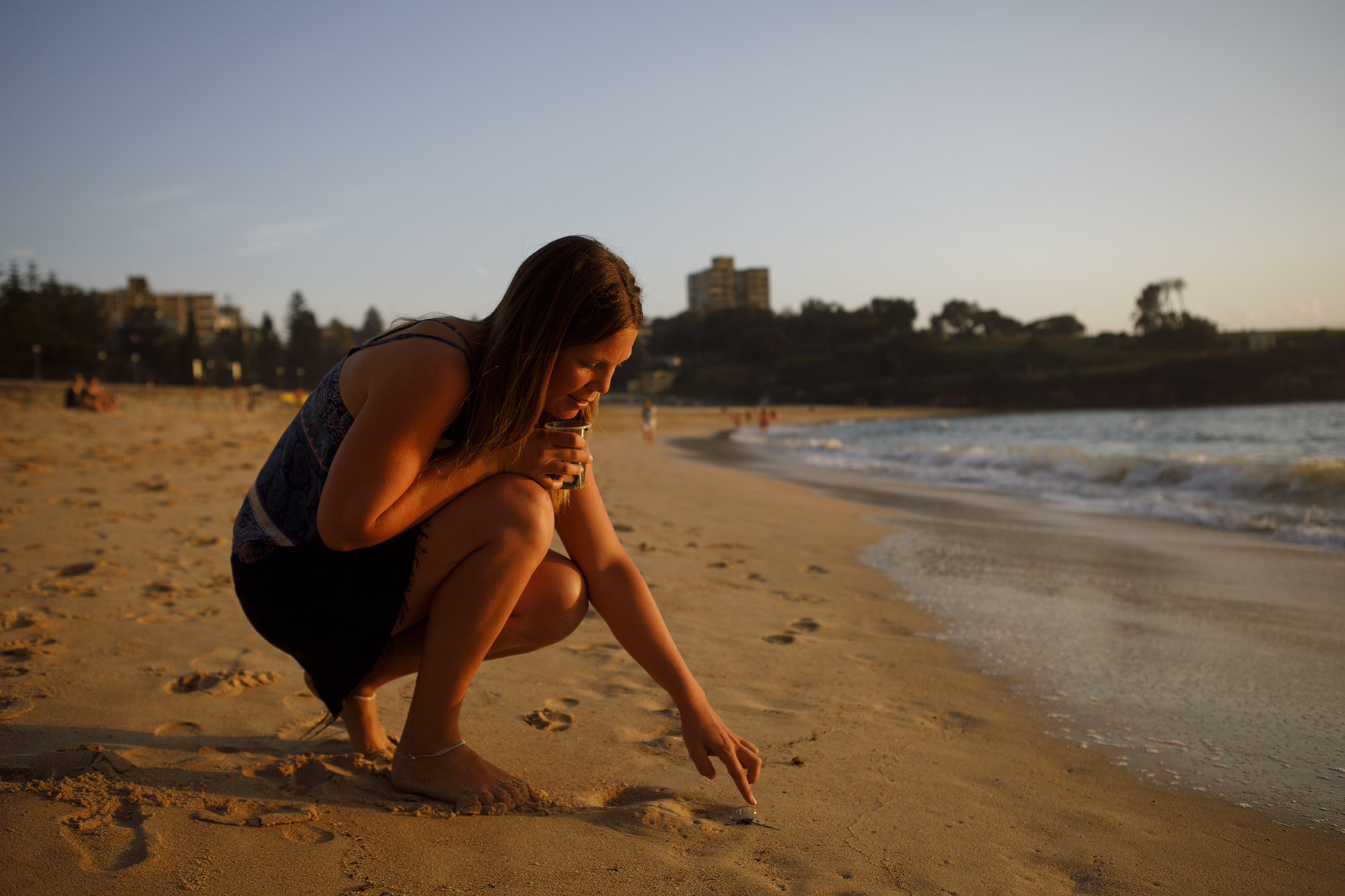 University of NSW Physical Oceanographer Dr Amandine Schaeffer at Coogee Beach looking at some bluebottle jellyfish samples as part of a research project.