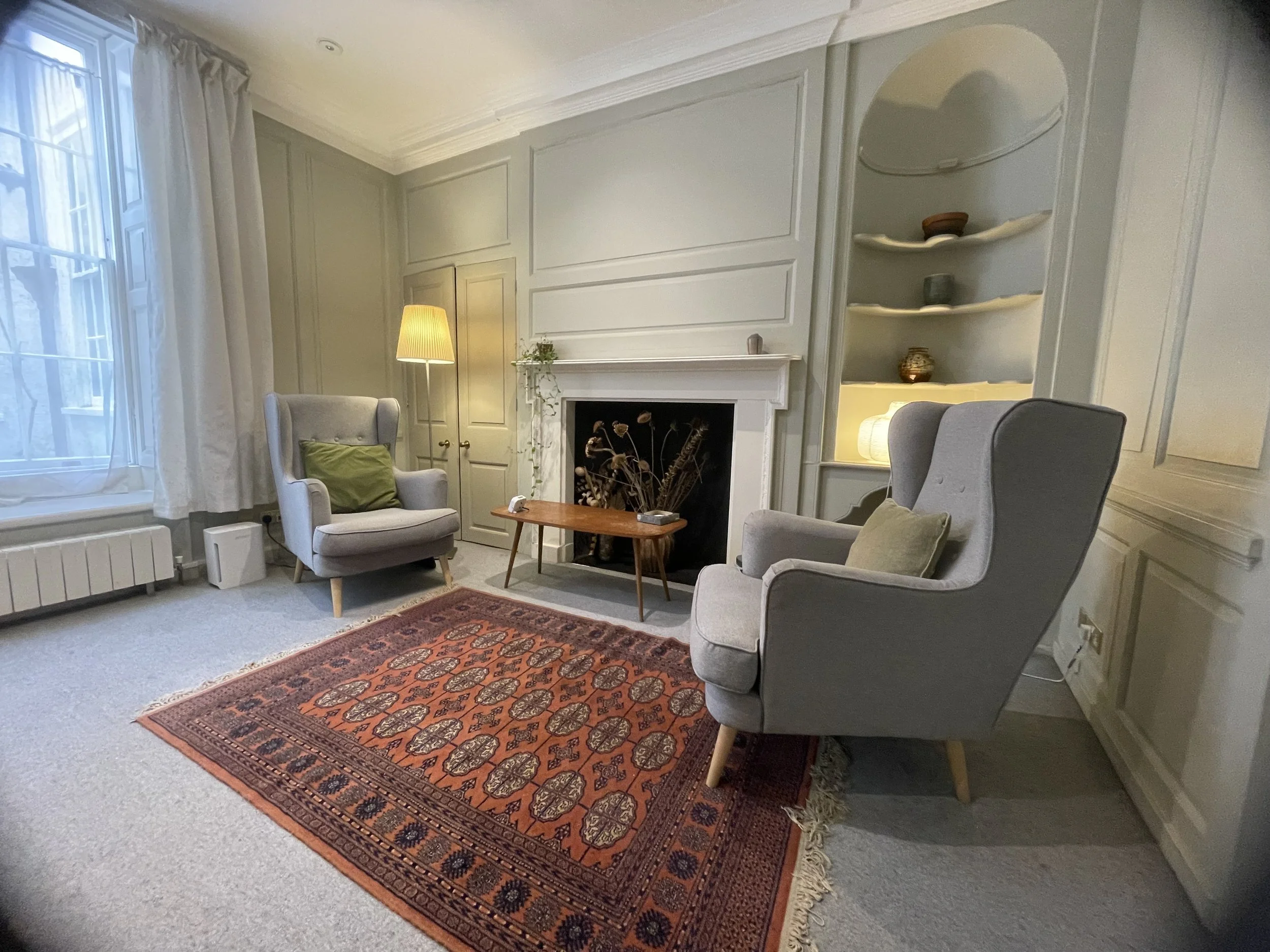Quiet psychotherapy consulting room in Bristol with chairs and natural light