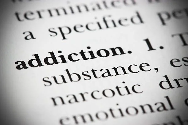 Close-up of a dictionary page with the word "addiction" in bold.