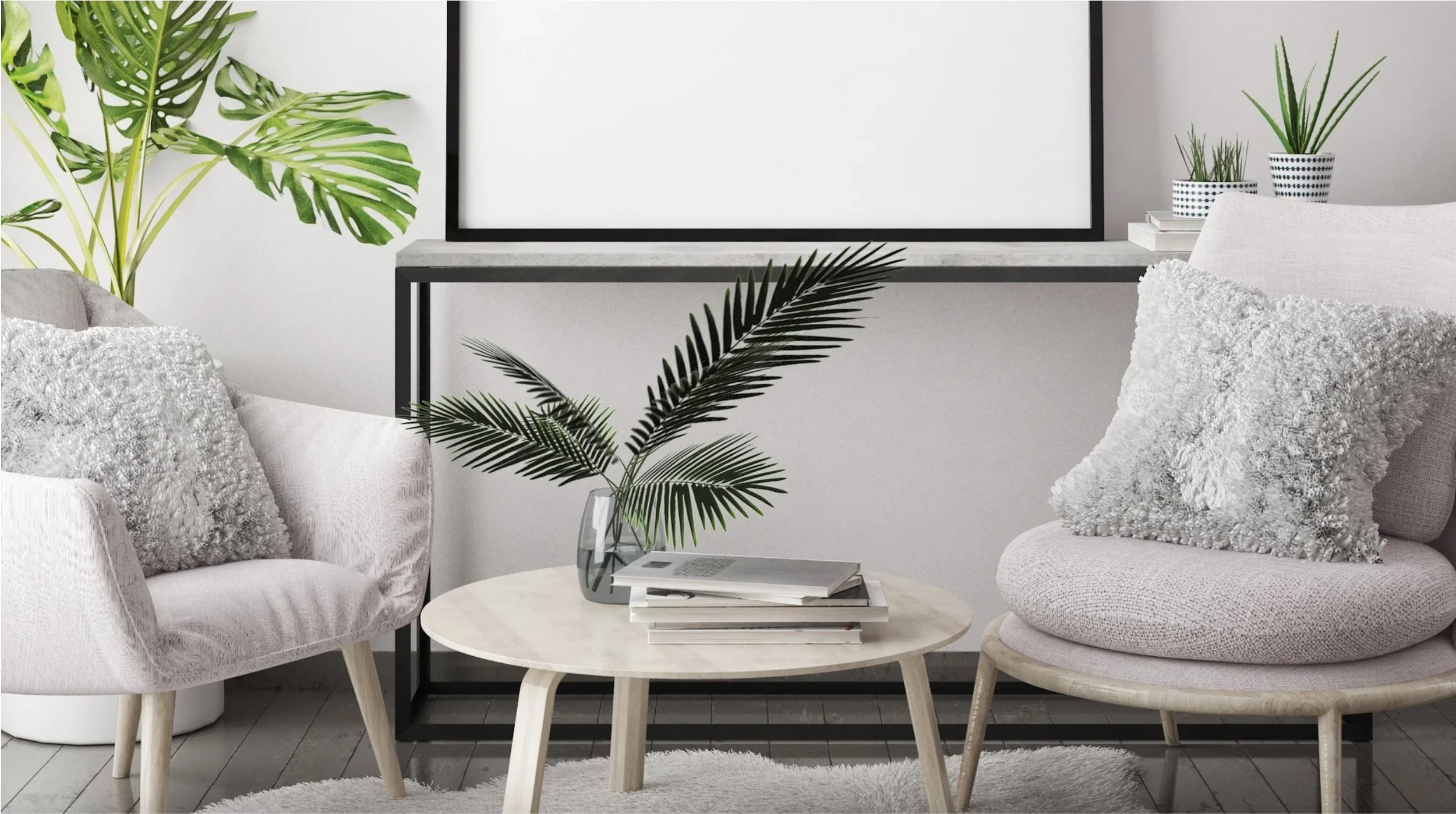 Modern living room with two light-colored armchairs with textured pillows, a round coffee table with a vase of palm leaves and magazines, large potted plants, and a picture frame on the wall.