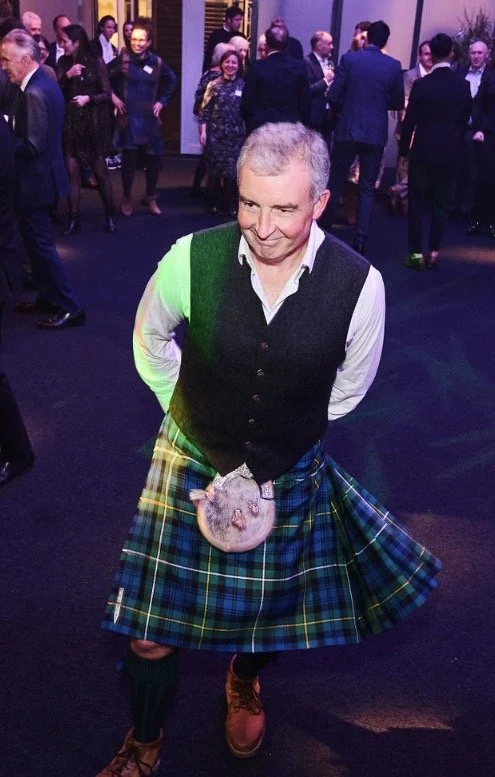 Alastair, ceilidh caller with The Hoggies, in a kilt on the dance floor