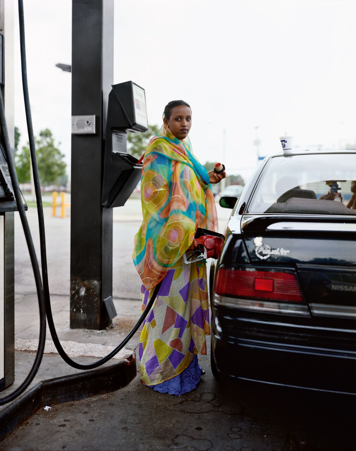 A Woman Pumping Gasoline, Kasas City, Kansas, June 1999