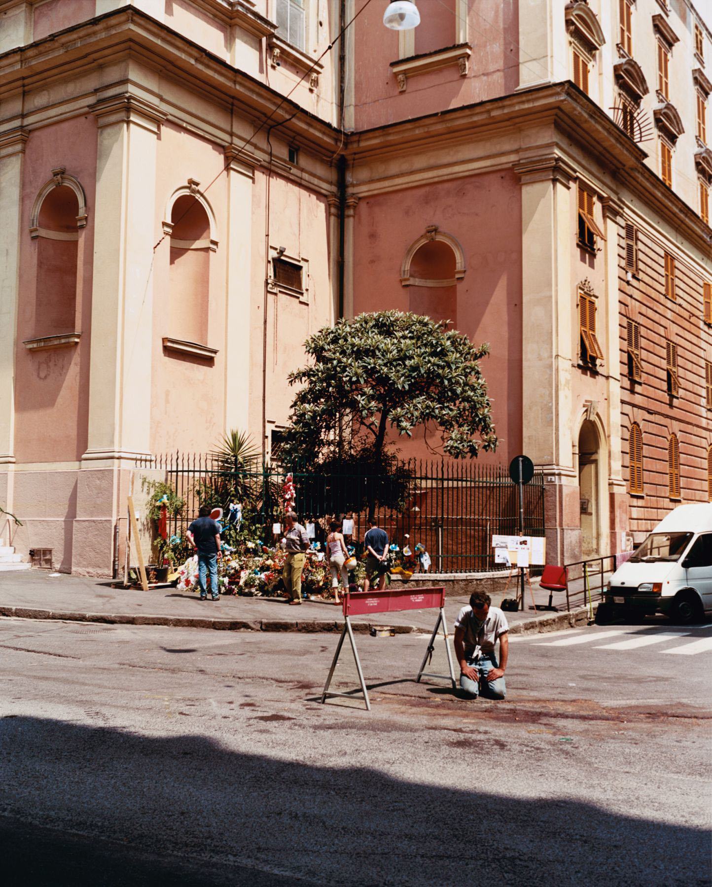 A man kneeling at the spot where Carlo Giuliani lost his life, Piazza Alimonda, Genoa, 21 July 2001