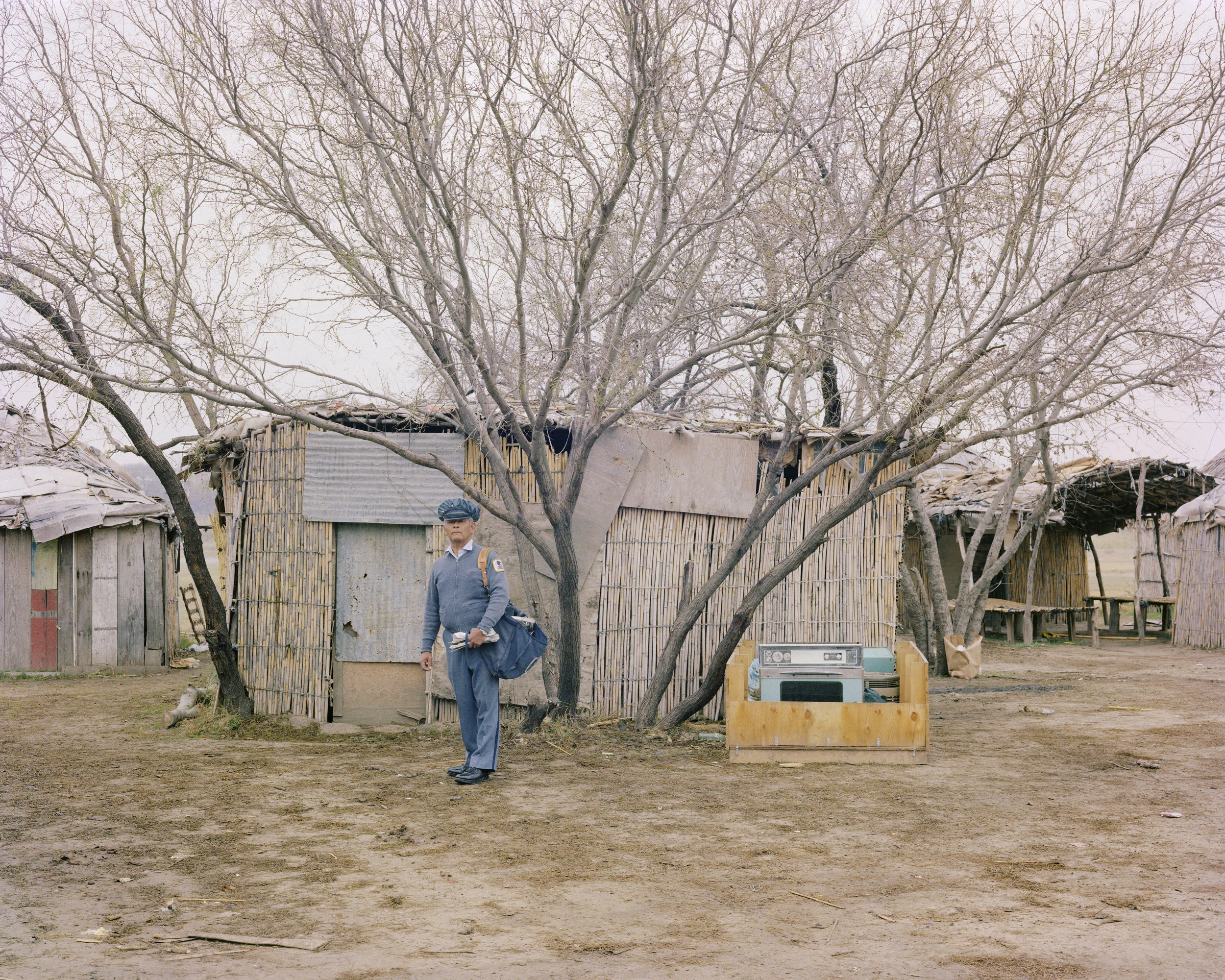 A Letter Carrier Delivering Mail in a Kickapoo Tribe Village, Eagle Pass, Texas, January 1983