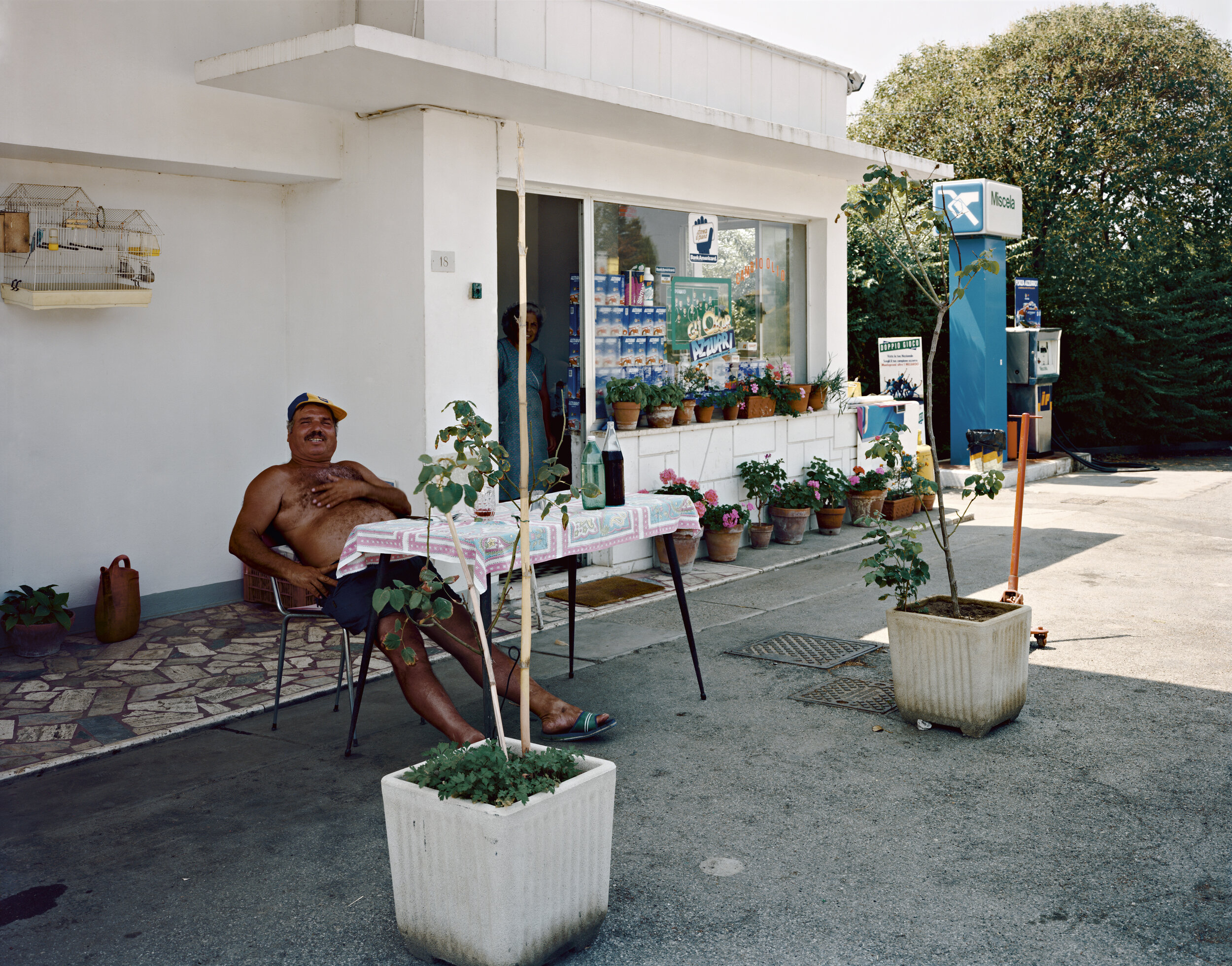 The proprietor of a gas station on a hot afternoon, near Via Castel di Guido, Rome, August 1990