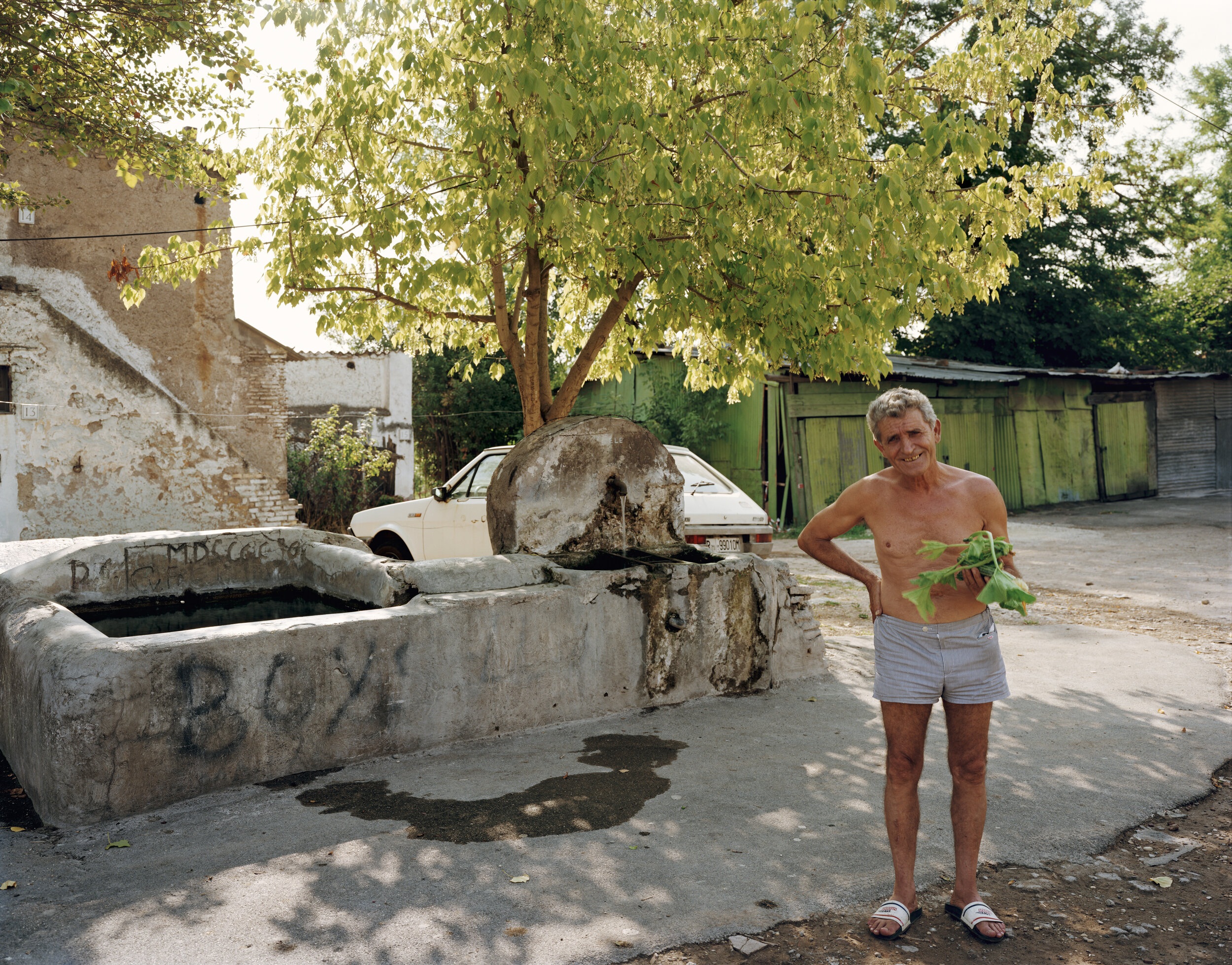 A man who has just washed kohlrabi in a fountain, Roma Vecchia, August 1990