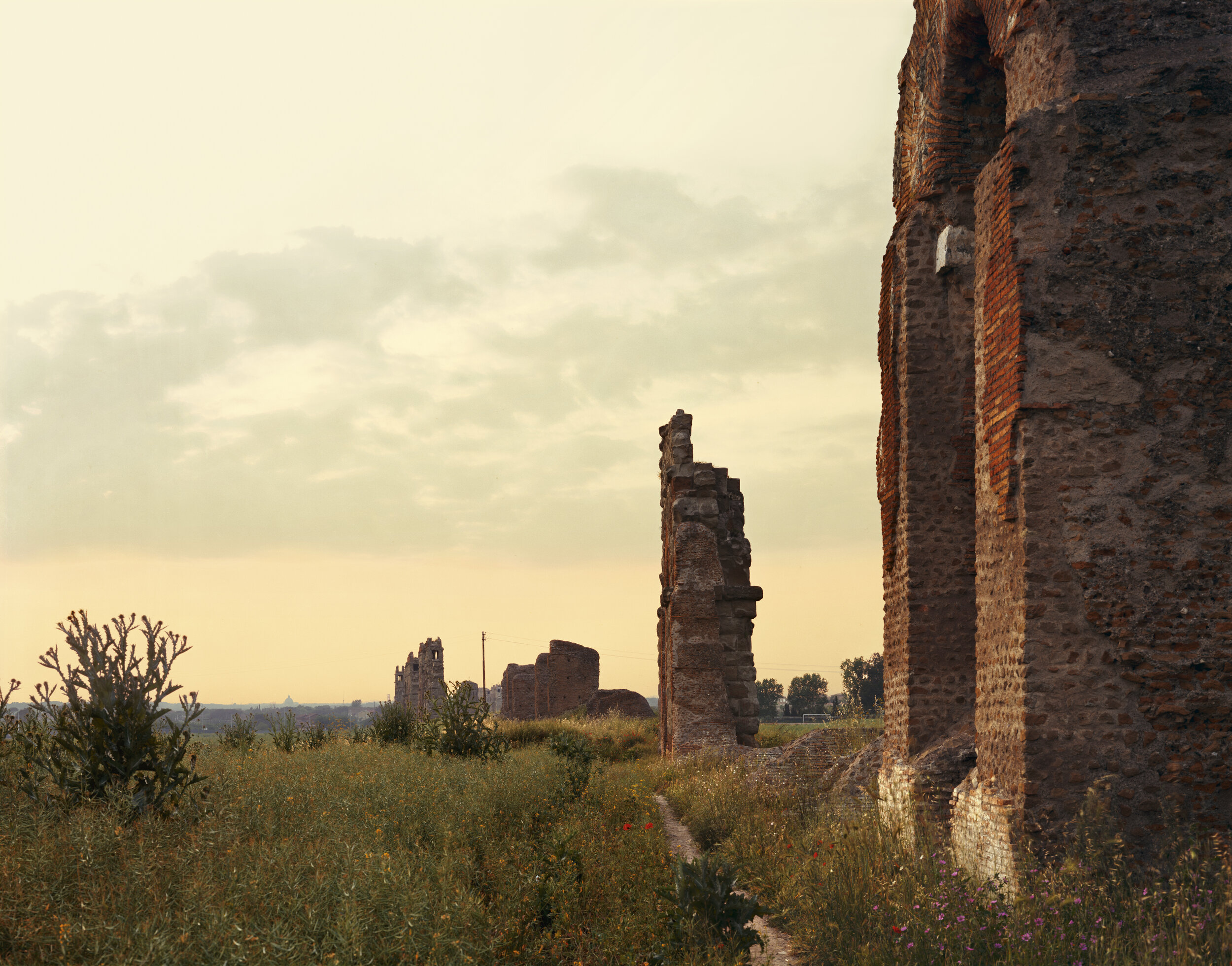 Remnant of the Claudian Aqueduct. The dome of the Vatican is visible on the horizon.  June 1989