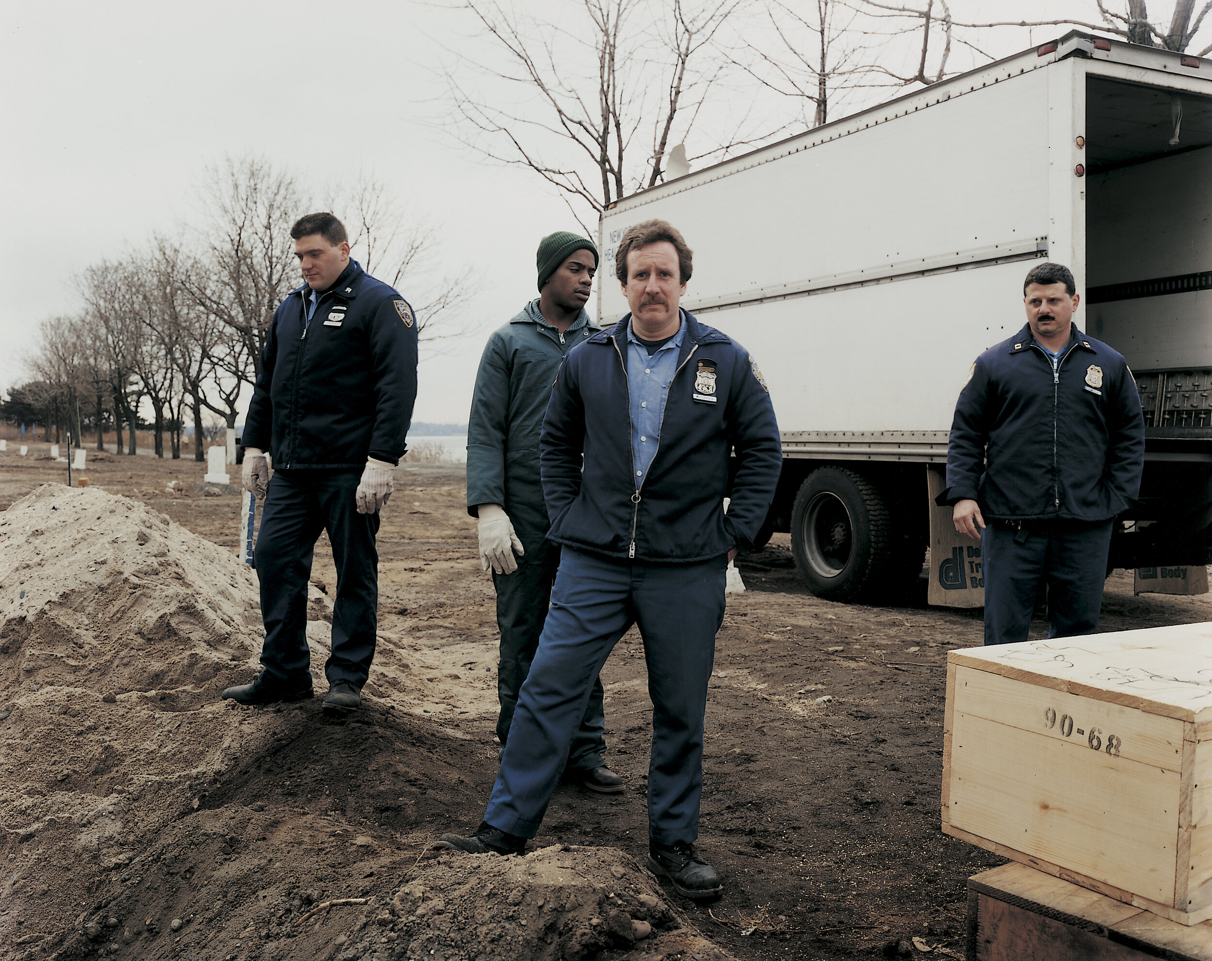 Correction officers and an inmate unloading the morgue truck, February 1992