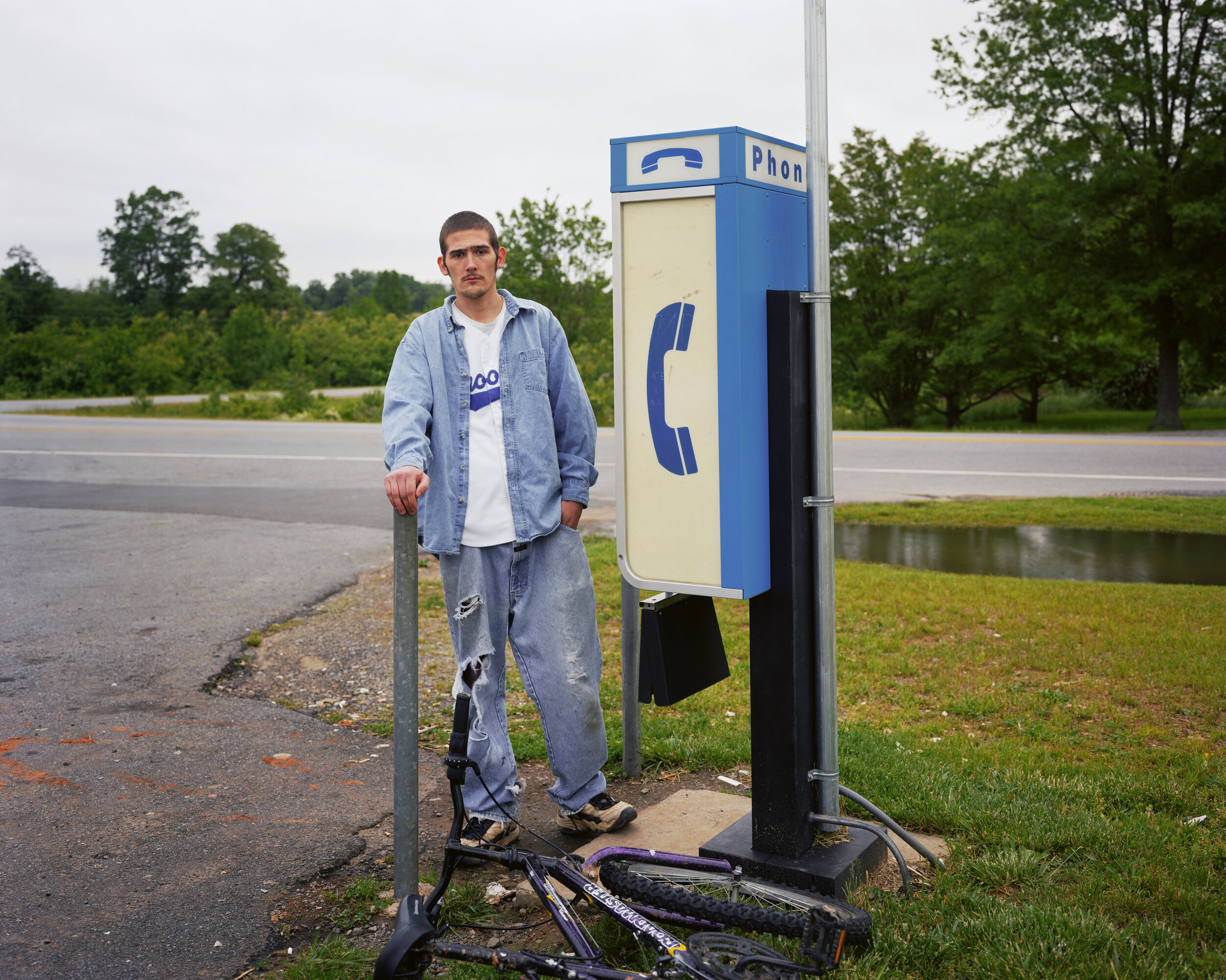 Man at a payphone, location unknown, date unknown