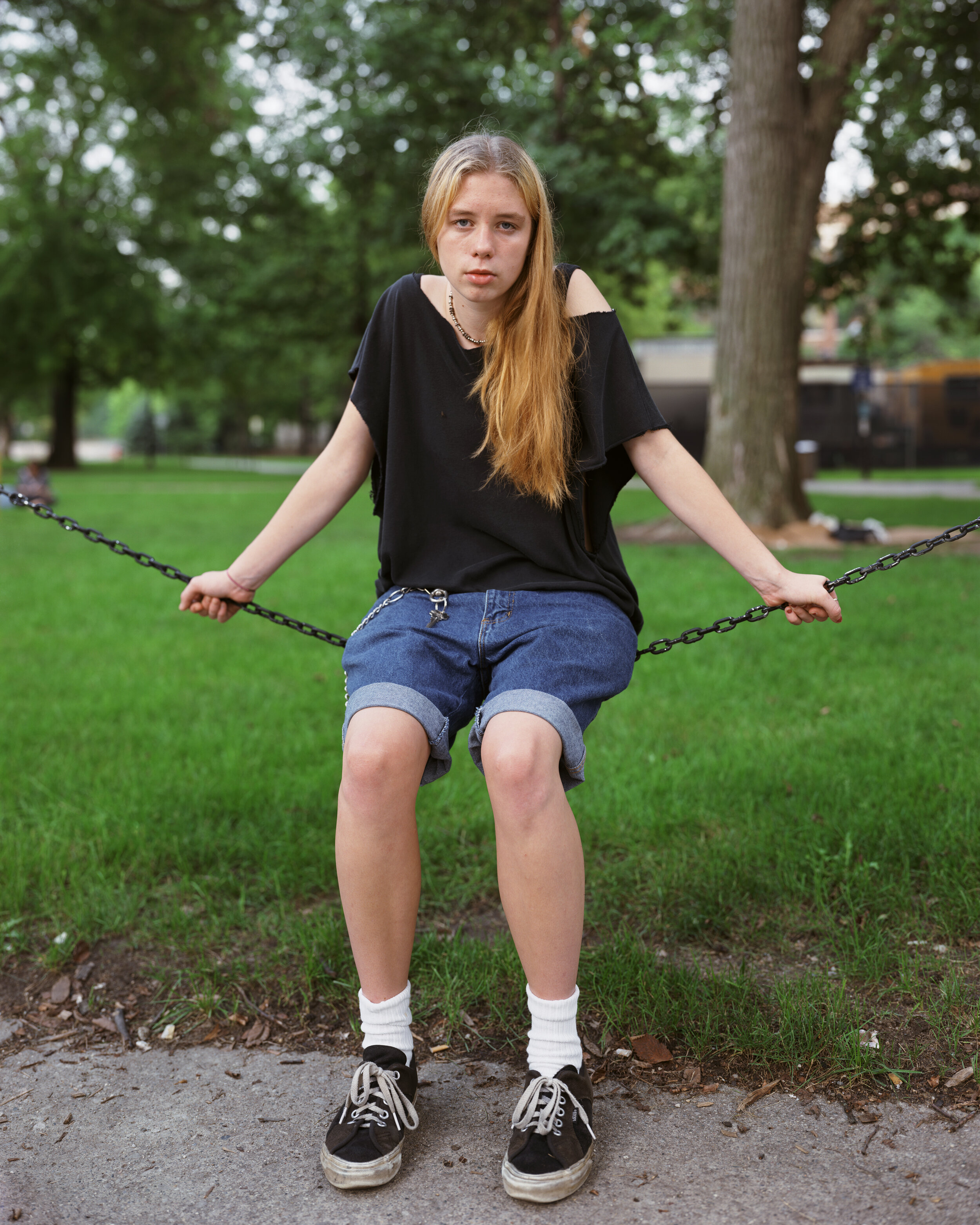 Young woman in a park, location unknown, date unknown