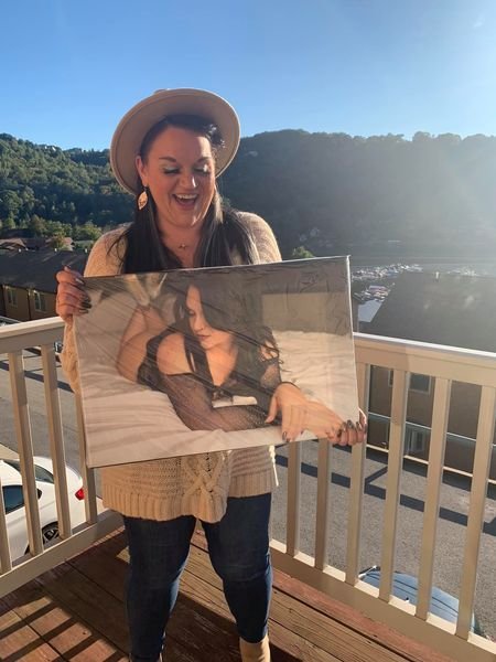 Woman holding a boudoir photo in West Virginia