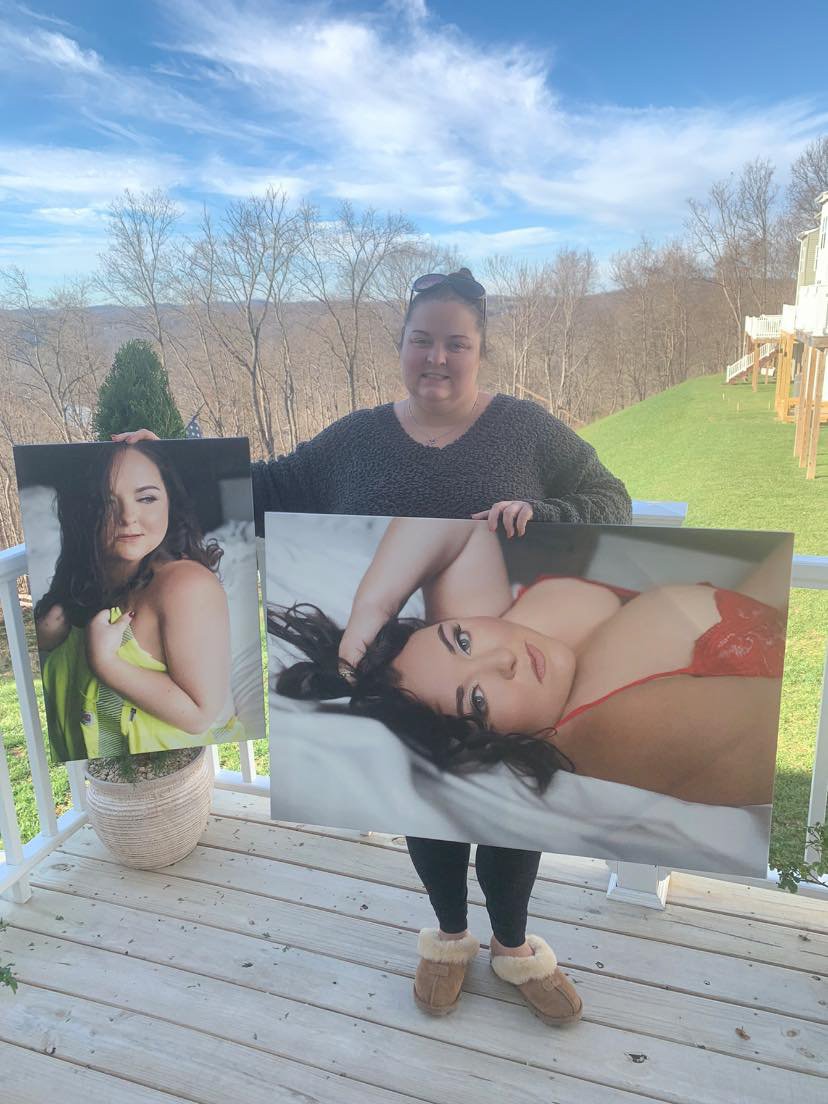 Woman holding a printed boudoir photos in West Virginia