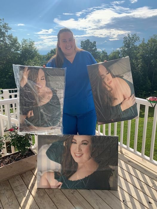 Woman holding printed boudoir photos in West Virginia
